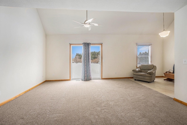 carpeted spare room with high vaulted ceiling, ceiling fan, and a wealth of natural light