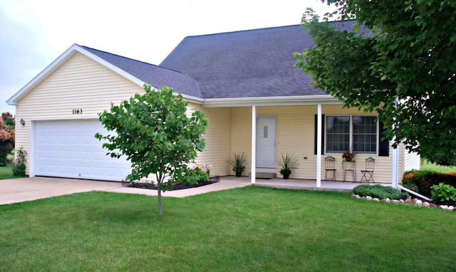 view of front of home with covered porch, a garage, and a front lawn