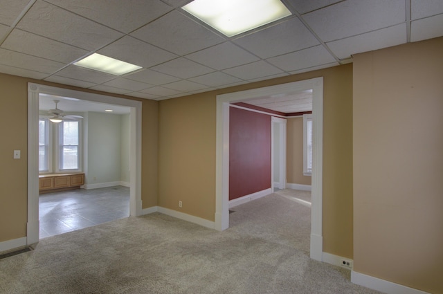 spare room featuring light carpet, a paneled ceiling, and ceiling fan