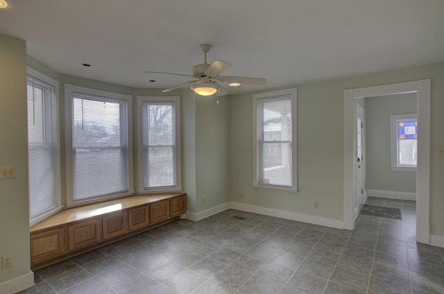 tiled empty room with ceiling fan