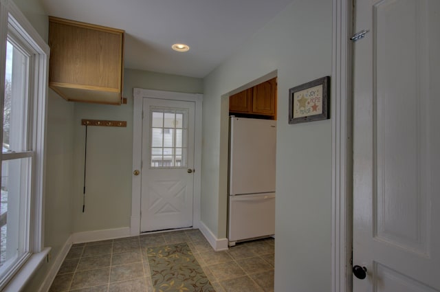 entryway featuring light tile patterned floors and plenty of natural light