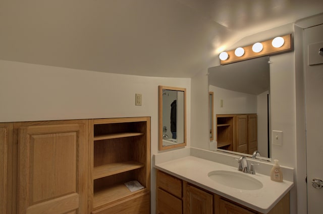 bathroom featuring vanity and vaulted ceiling