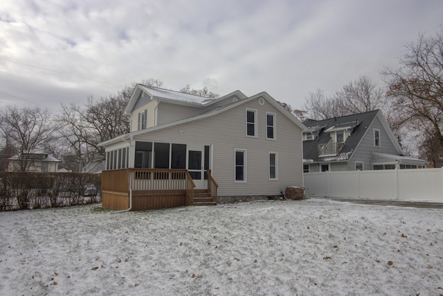 rear view of house featuring a sunroom