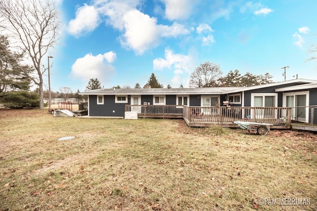 view of front of home featuring a front lawn and a wooden deck