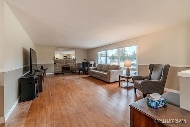 living room with a fireplace and light hardwood / wood-style flooring