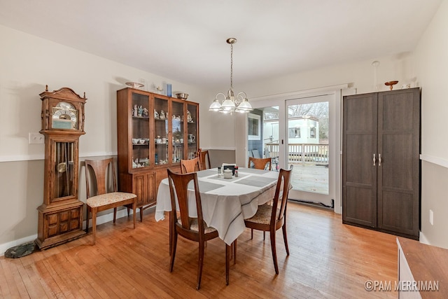 dining area featuring a notable chandelier and light hardwood / wood-style flooring