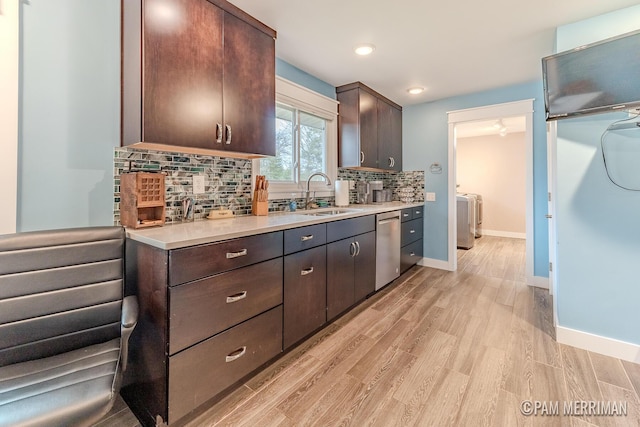 kitchen featuring dark brown cabinetry, light hardwood / wood-style floors, tasteful backsplash, and sink