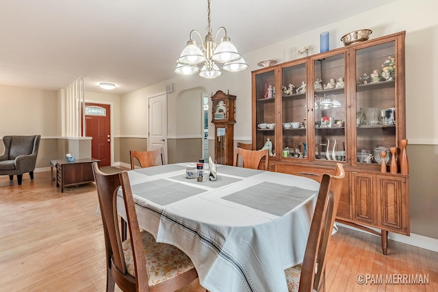 dining room featuring a chandelier and light hardwood / wood-style flooring