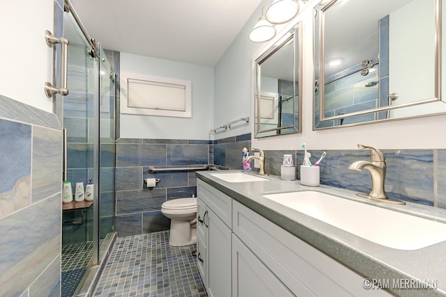 bathroom featuring tile patterned floors, walk in shower, vanity, tile walls, and toilet