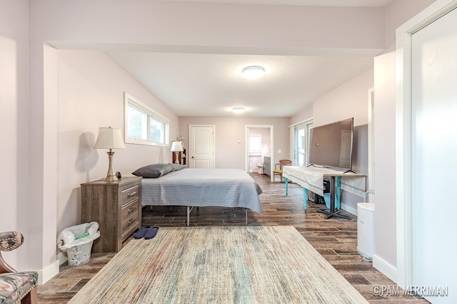 bedroom with dark hardwood / wood-style floors