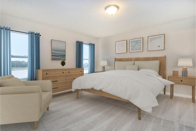 bedroom featuring light colored carpet and baseboards