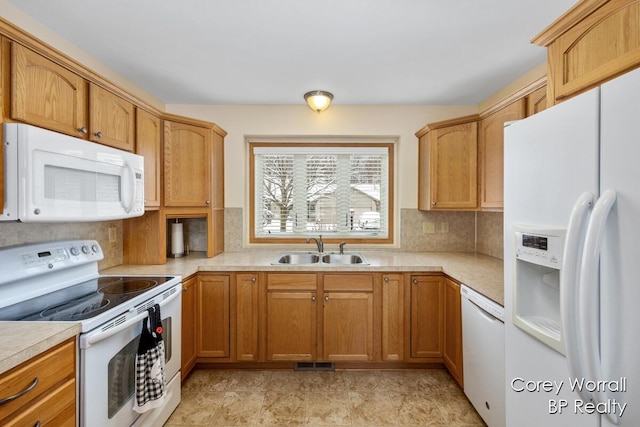 kitchen featuring white appliances, tasteful backsplash, and sink