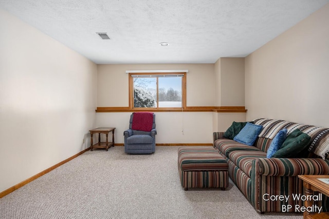 carpeted living room featuring a textured ceiling