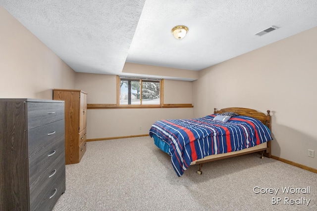 bedroom featuring carpet flooring and a textured ceiling