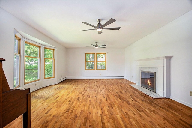 unfurnished living room featuring a baseboard heating unit, a premium fireplace, and light hardwood / wood-style flooring