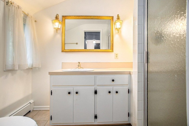 bathroom featuring vanity, lofted ceiling, a baseboard heating unit, tile patterned floors, and a shower with shower door