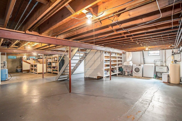 basement featuring washing machine and dryer and sink