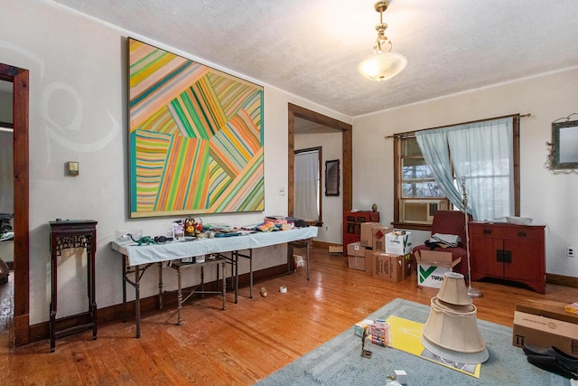 dining space featuring hardwood / wood-style floors and a textured ceiling