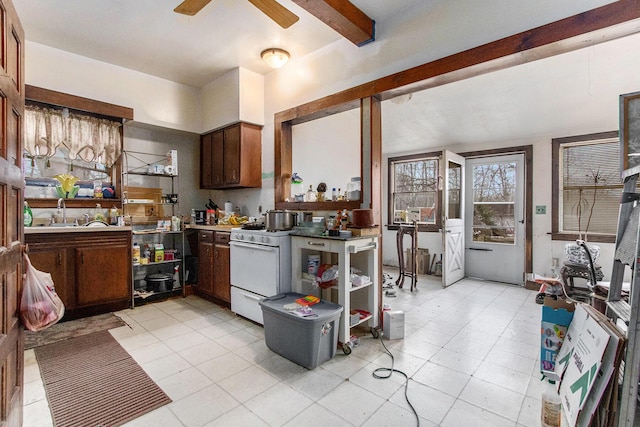 kitchen featuring beamed ceiling, light tile patterned floors, white range, and ceiling fan