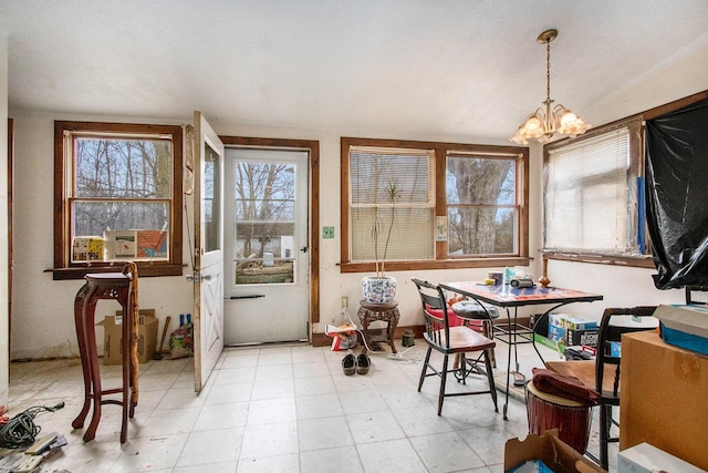 sunroom with vaulted ceiling and a chandelier