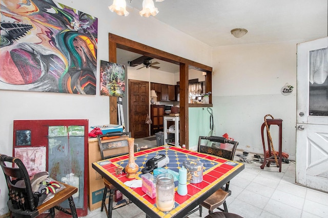 dining area with ceiling fan with notable chandelier