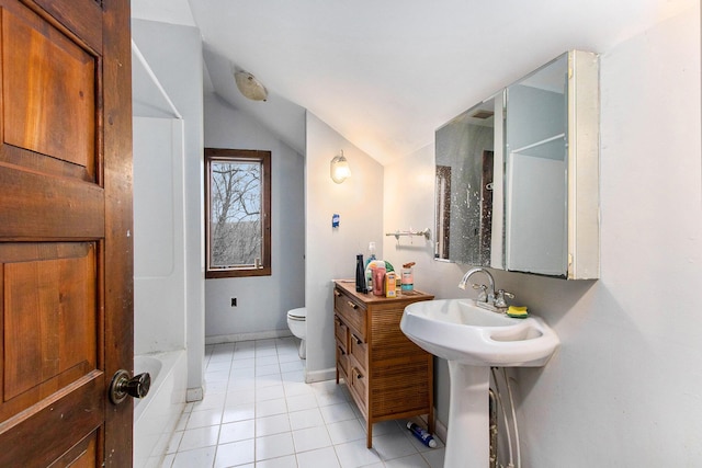 bathroom featuring tile patterned floors, toilet, lofted ceiling, and sink