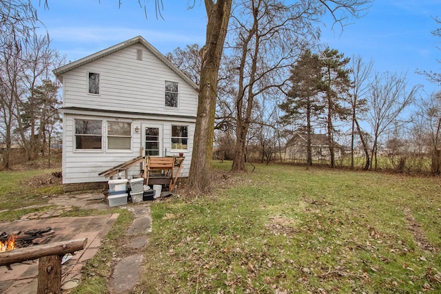 rear view of property featuring a patio area and a yard