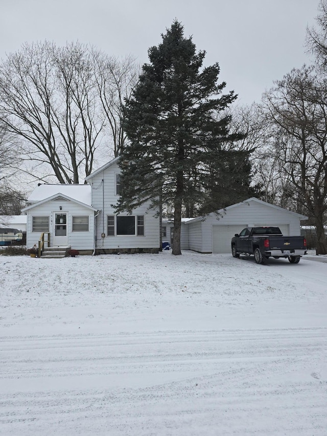 view of front of house with a garage and an outdoor structure