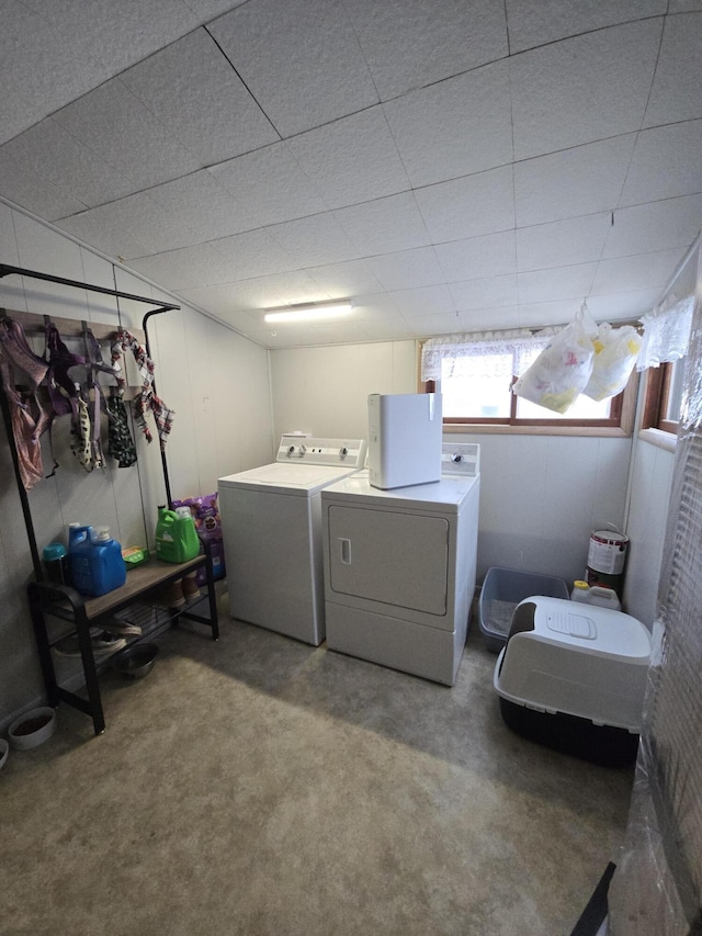 clothes washing area with washing machine and clothes dryer and carpet flooring