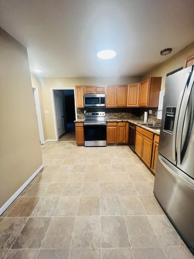 kitchen with sink, backsplash, and appliances with stainless steel finishes