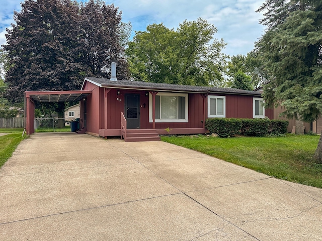 view of front of property with a carport and a front lawn