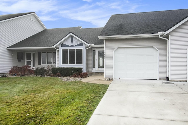 view of front facade featuring a front lawn and a garage