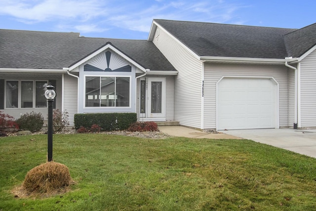 view of front facade featuring a front yard and a garage