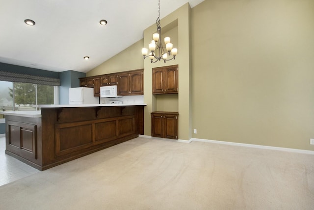 kitchen with pendant lighting, a notable chandelier, white appliances, and light carpet