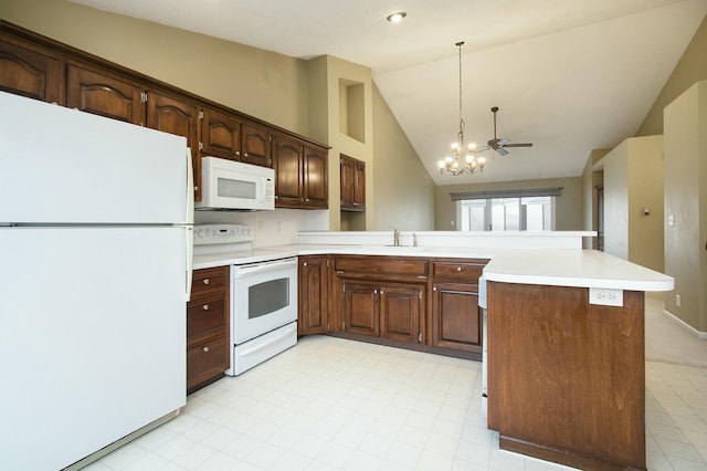 kitchen with sink, high vaulted ceiling, decorative light fixtures, white appliances, and ceiling fan with notable chandelier