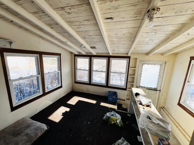 interior space featuring vaulted ceiling with beams, plenty of natural light, and wooden ceiling