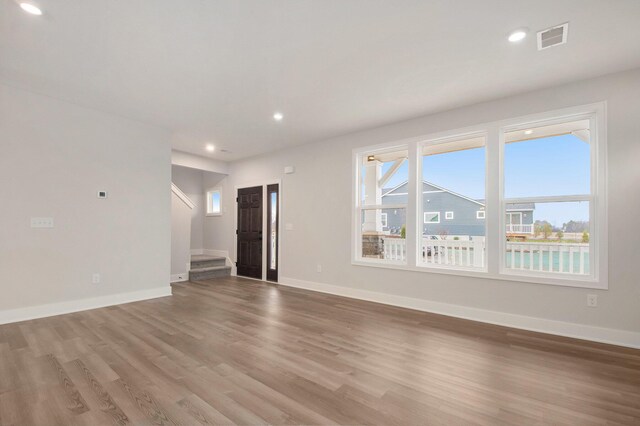 unfurnished living room featuring hardwood / wood-style flooring