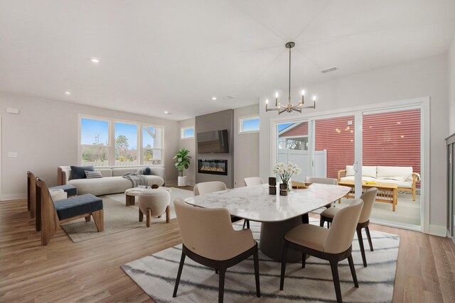 dining room featuring light hardwood / wood-style flooring and a chandelier