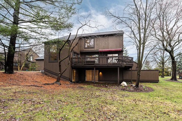 rear view of house with a yard and a deck