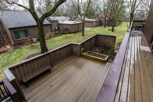 wooden terrace featuring a lawn and cooling unit