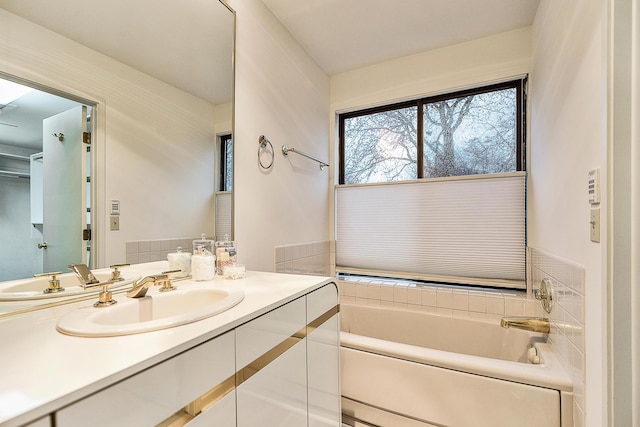 bathroom with a bath and vanity