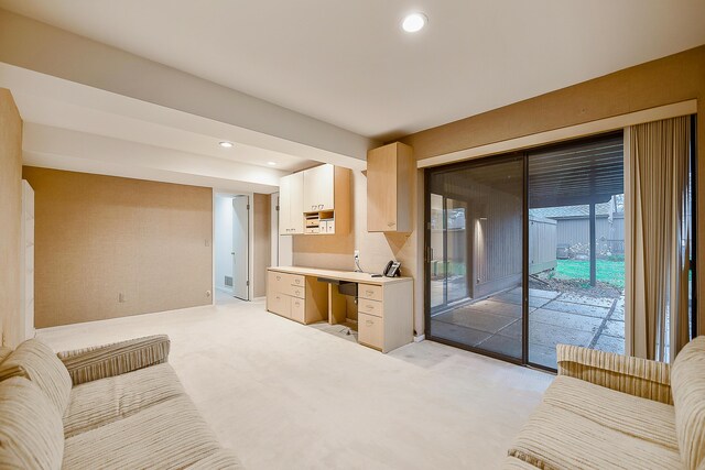 living area featuring light carpet and recessed lighting