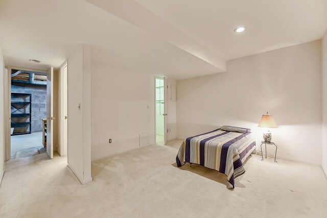 bedroom featuring light carpet, baseboards, and recessed lighting