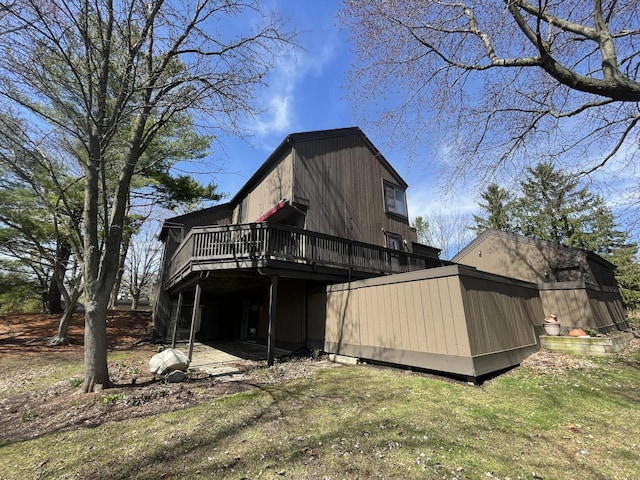 rear view of house featuring a wooden deck