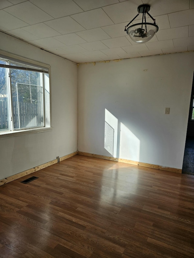 empty room featuring dark wood-type flooring