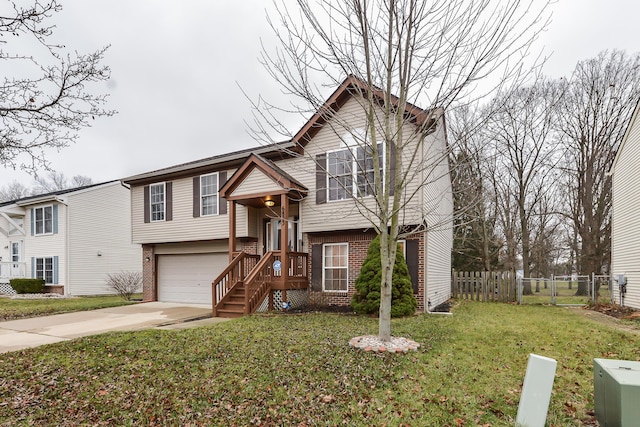 split foyer home with a garage and a front lawn