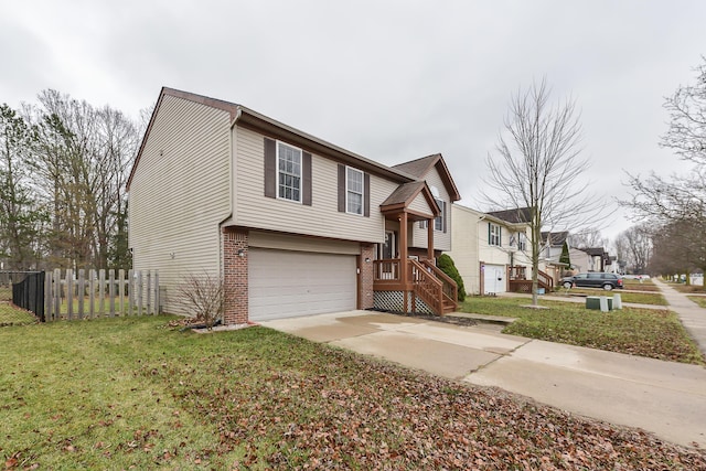 split foyer home featuring a front lawn and a garage