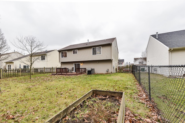 back of house with a deck and a yard