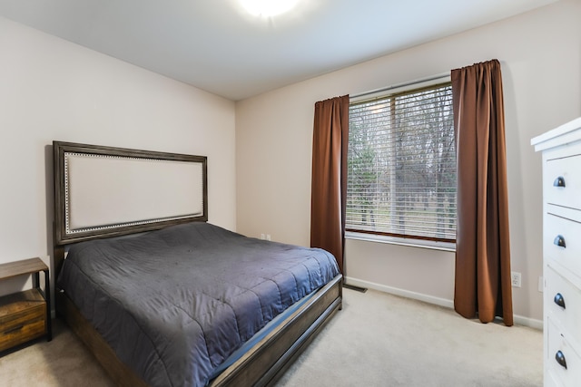 bedroom featuring light colored carpet