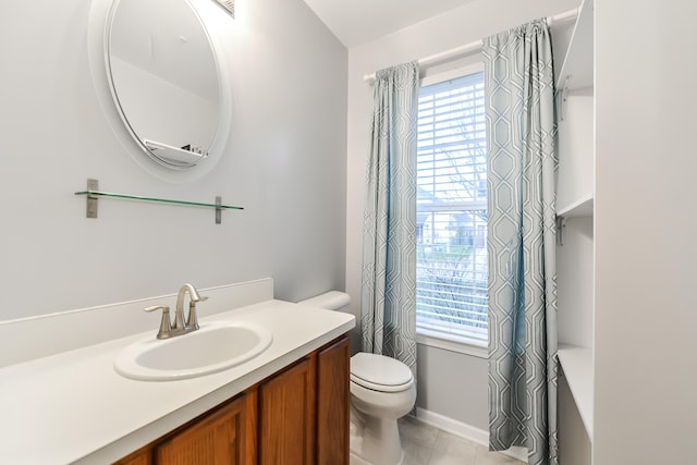 bathroom featuring tile patterned floors, vanity, and toilet